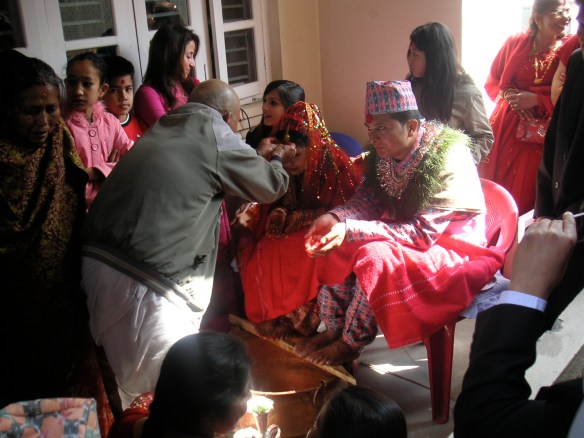 The parents wash their new son/daughter's feet