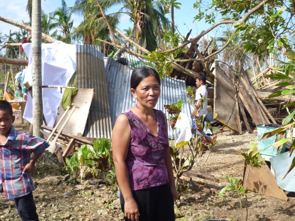 Mary-Ann Bantilan, in front of her makeshift shelter under the tree that fell on her house.
